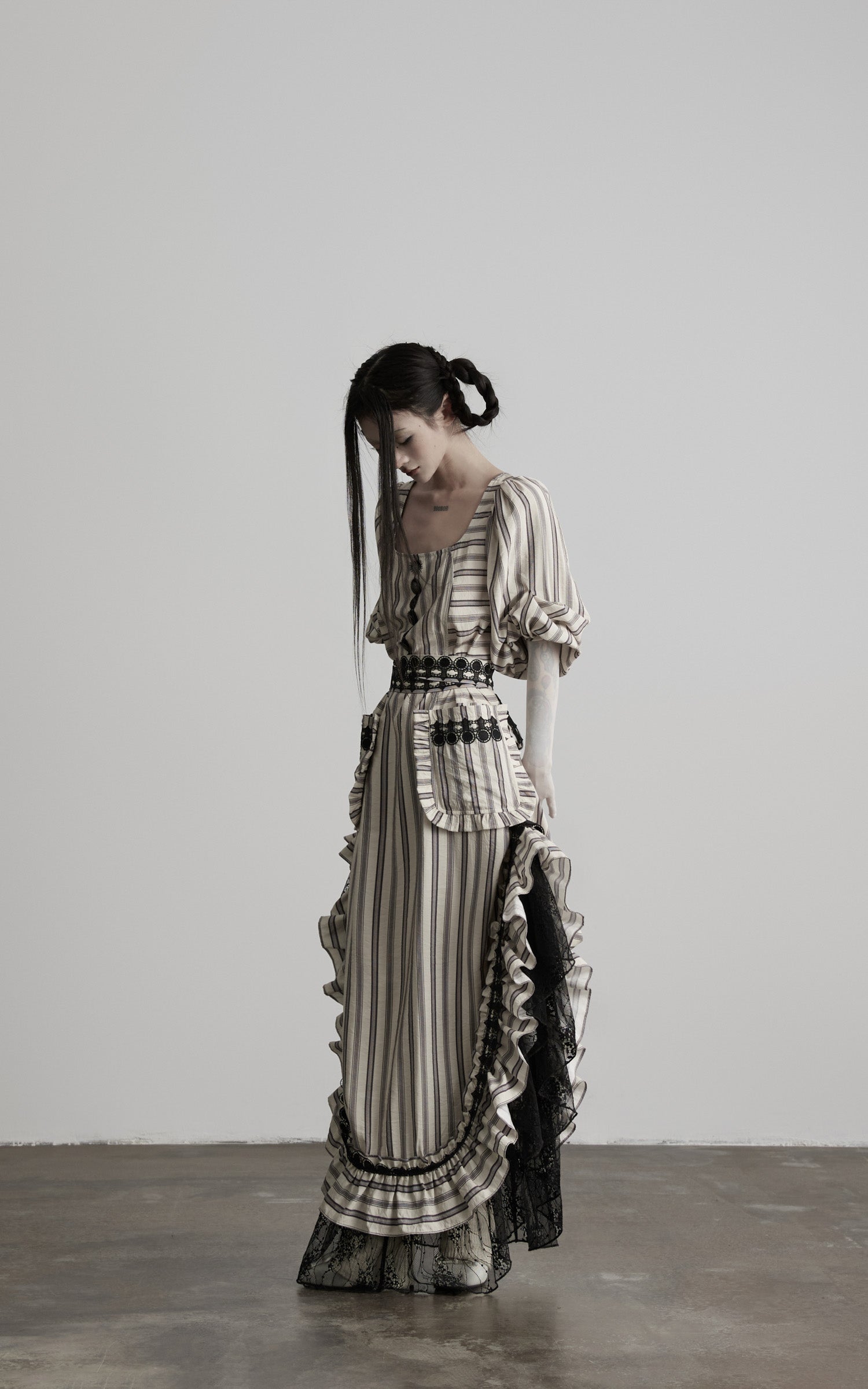 side view of beige striped maxi dress with layered lace trim