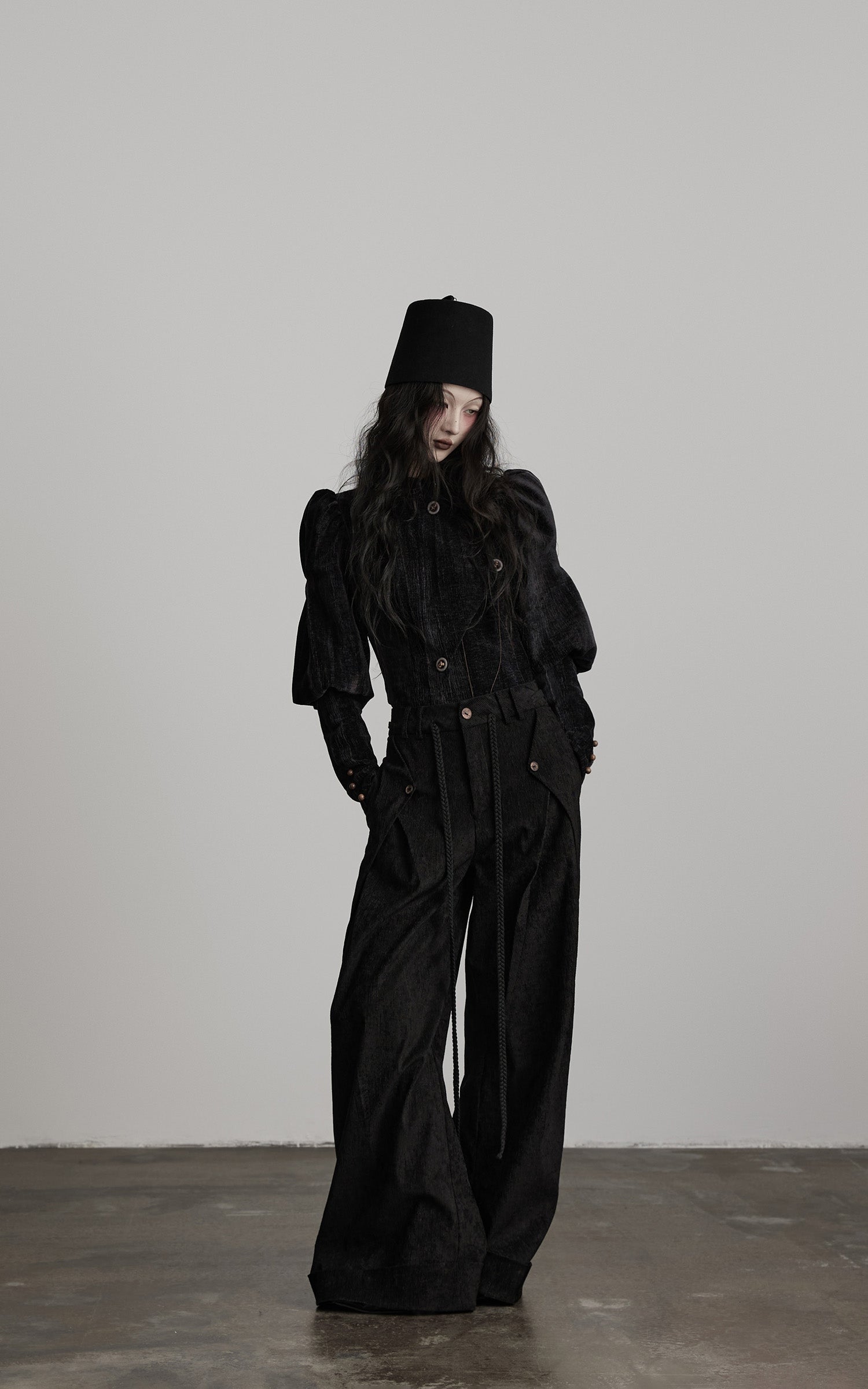 front view of black textured wide leg pants with elongated silhouette