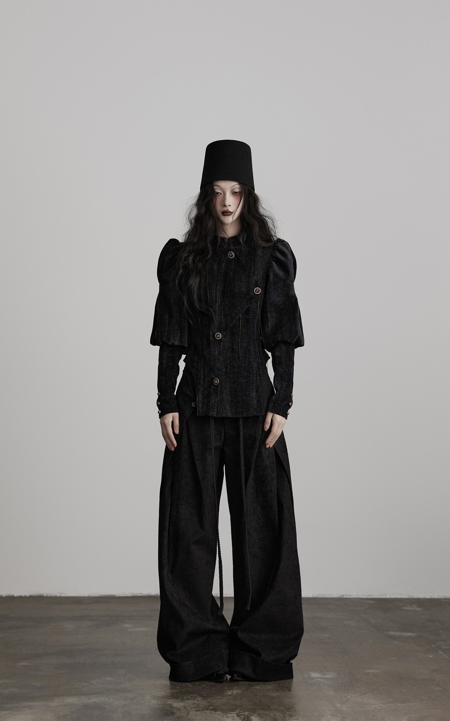 front view of black textured wide leg pants with high waist structure