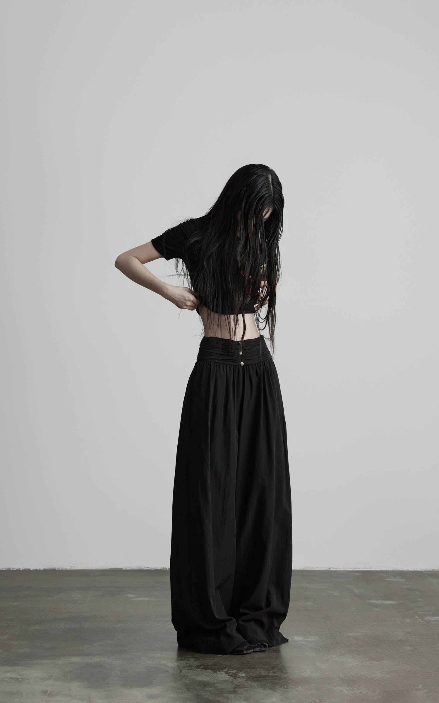 Black wide leg gathered waist pants angled front full view
