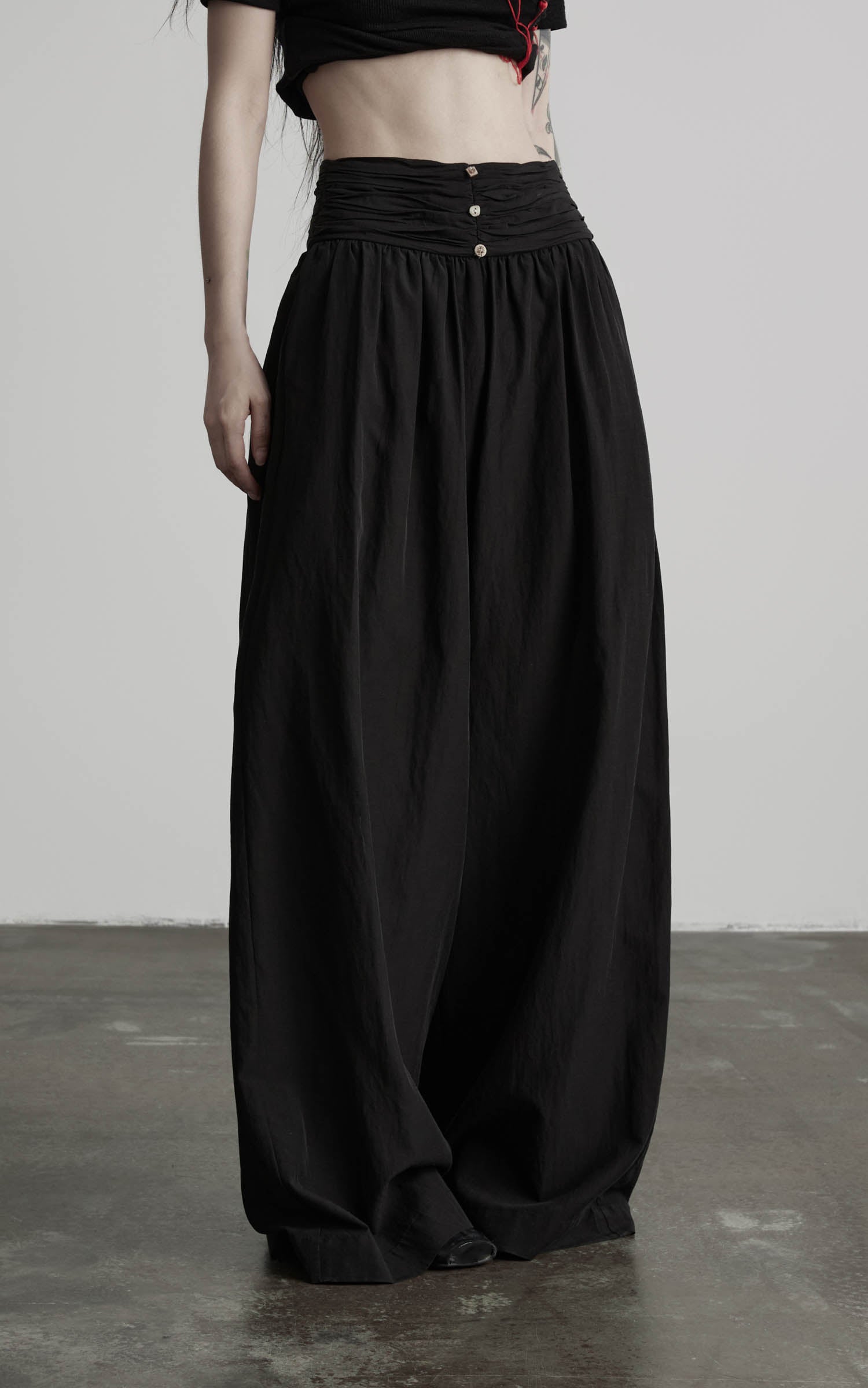 Black wide leg gathered waist pants angled front detail view