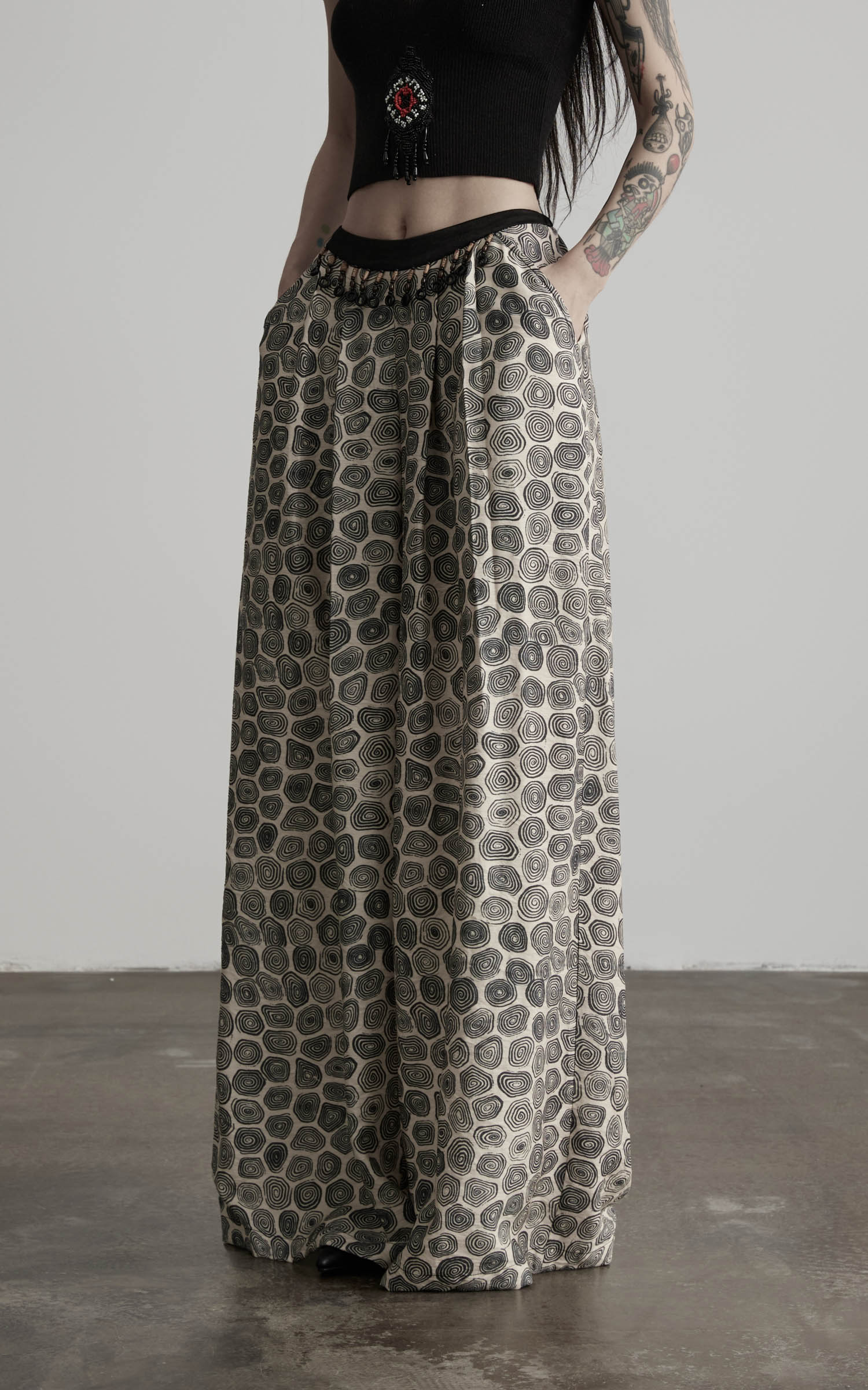close-up of patterned wide leg pants with textured fabric and drape