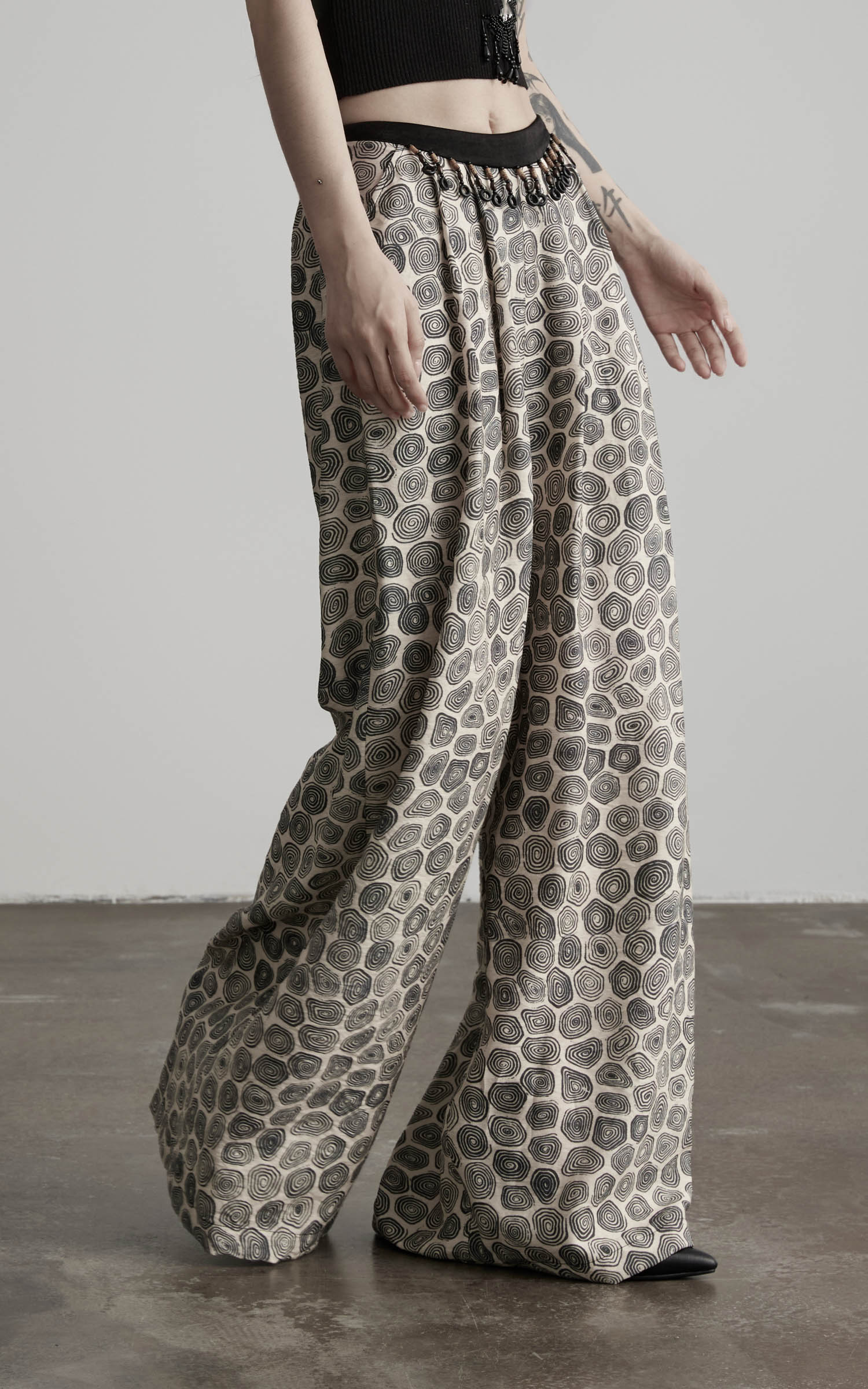 side view of patterned wide leg pants with flowing hem and loose drape